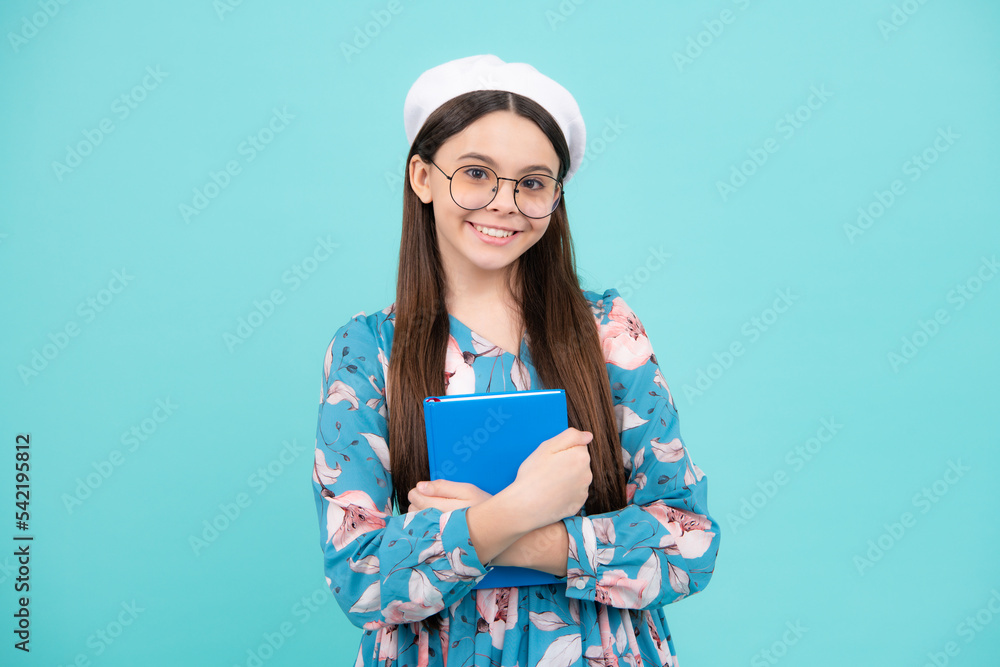 Back to school. Teenager schoolgirl with book ready to learn. School girl children on isolated blue studio background. Happy teenager, positive and smiling emotions. Back to school. Teenager schoolgirl with book ready to learn. School girl children on isolated blue studio background. Happy teenager, positive and smiling emotions.
