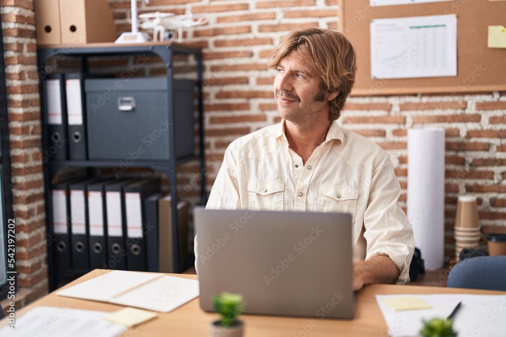 Young man business worker using laptop working at office Young man business worker using laptop working at office