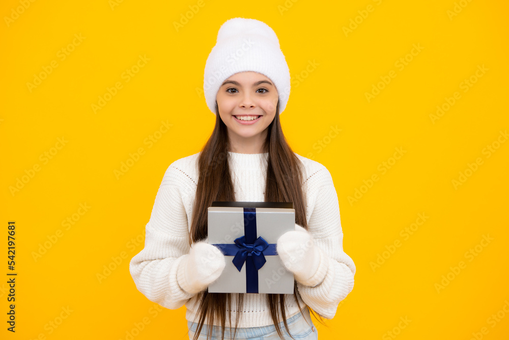 Teenager child hold gift on birthday. Funny kid girl in winter wear holding gift boxes celebrating happy New Year or Christmas. Winter holiday. Teenager child hold gift on birthday. Funny kid girl in winter wear holding gift boxes celebrating happy New Year or Christmas. Winter holiday.