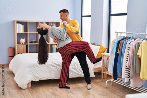 Man and woman couple dancing at bedroom
