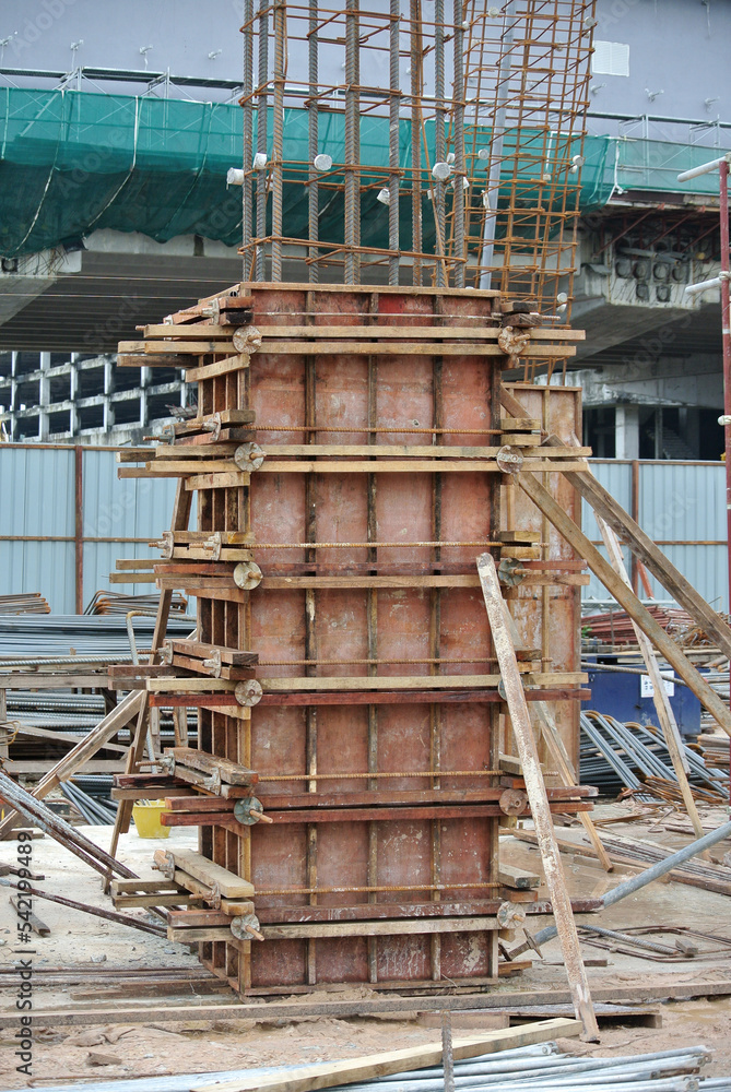 MALACCA, MALAYSIA -APRIL 26, 2016: Column form work made from timber and plywood fabricated at the construction site by workers. MALACCA, MALAYSIA -APRIL 26, 2016: Column form work made from timber and plywood fabricated at the construction site by workers.