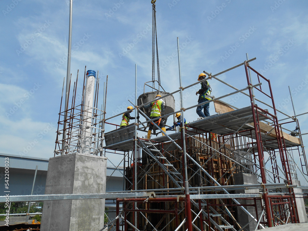 Fototapeta premium SEPANG, MALAYSIA APRIL 08, 2015: Bar bending yard at the construction site. Construction workers bend the reinforcement bar to follow the design.