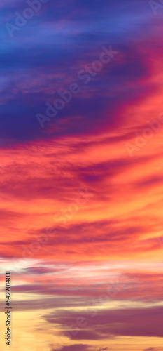 Sunset with sun and clouds on blue and orange dramatic sky. © GSDesign