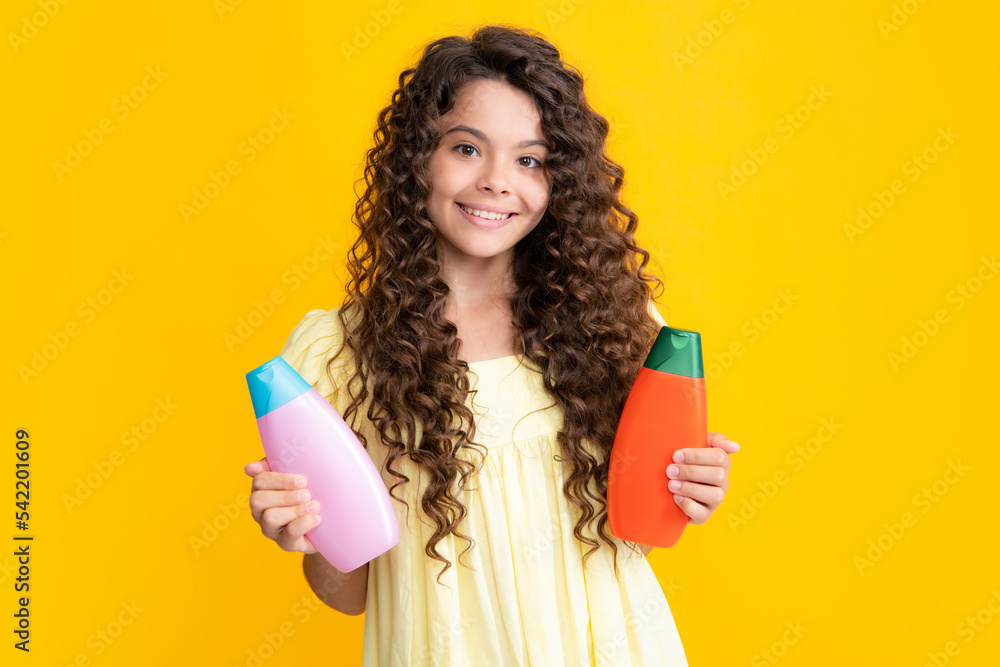 Teenage girl with shampoos conditioners or shower gel. Kids hair care cosmetic product, shampoo bottle. Happy teenager portrait. Smiling girl. Teenage girl with shampoos conditioners or shower gel. Kids hair care cosmetic product, shampoo bottle. Happy teenager portrait. Smiling girl.