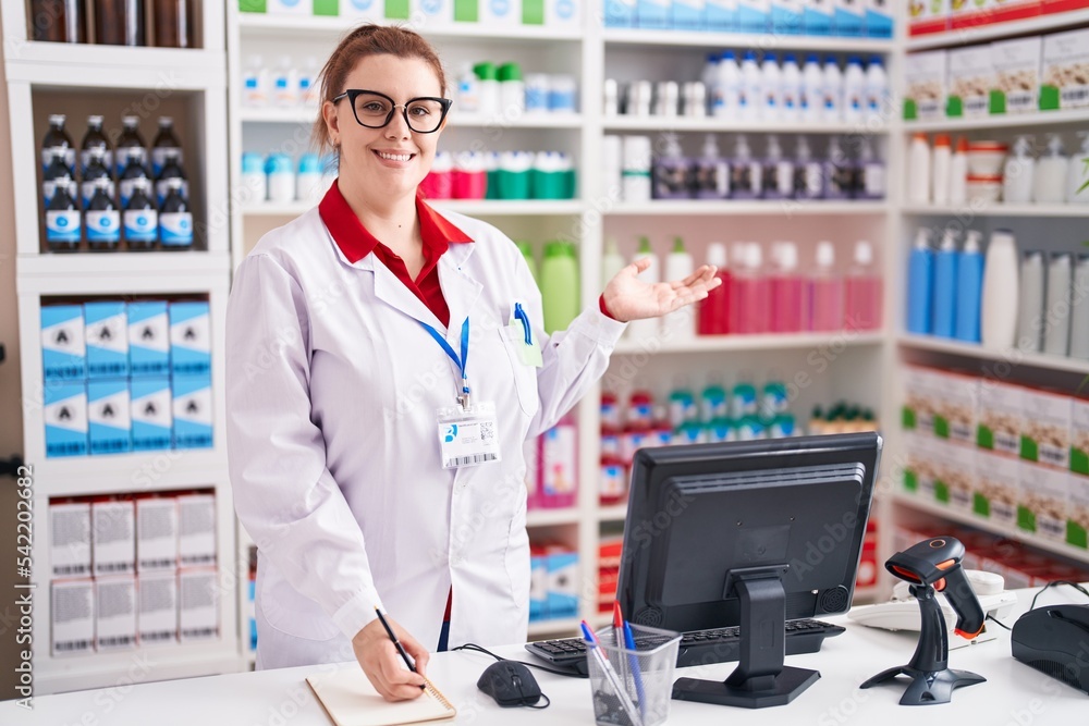 Young beautiful plus size woman pharmacist writing on notebook at pharmacy Young beautiful plus size woman pharmacist writing on notebook at pharmacy