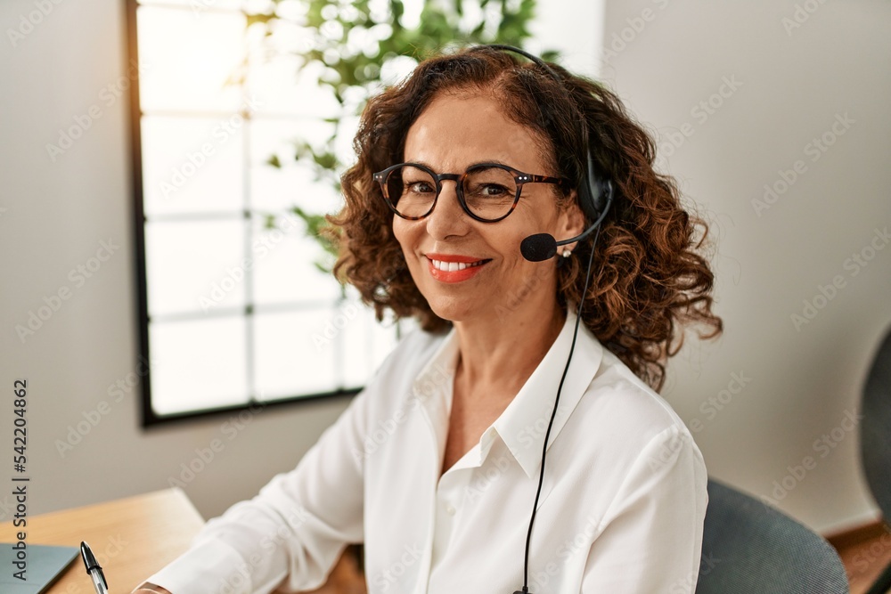 Middle age hispanic woman smiling confident working at office Middle age hispanic woman smiling confident working at office
