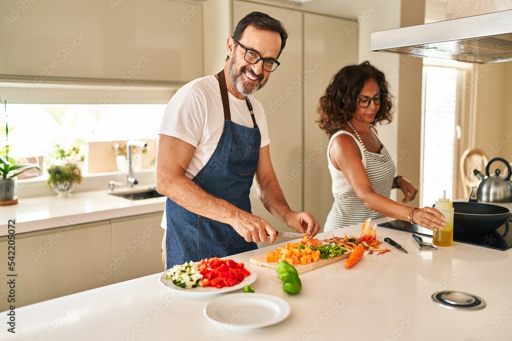 Middle age hispanic couple smiling confident cooking at kitchen Middle age hispanic couple smiling confident cooking at kitchen