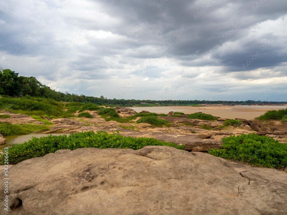 The rock field or rock shore with the green grass called Han Hong is famous in the middle of the Mekong river during the dry season.