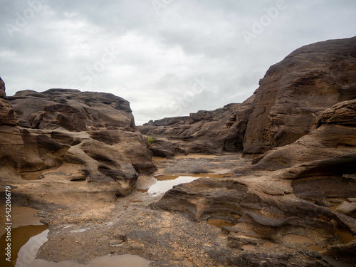 The canyon of rock field or rock shore in the middle of the Mekong river during the dry season.