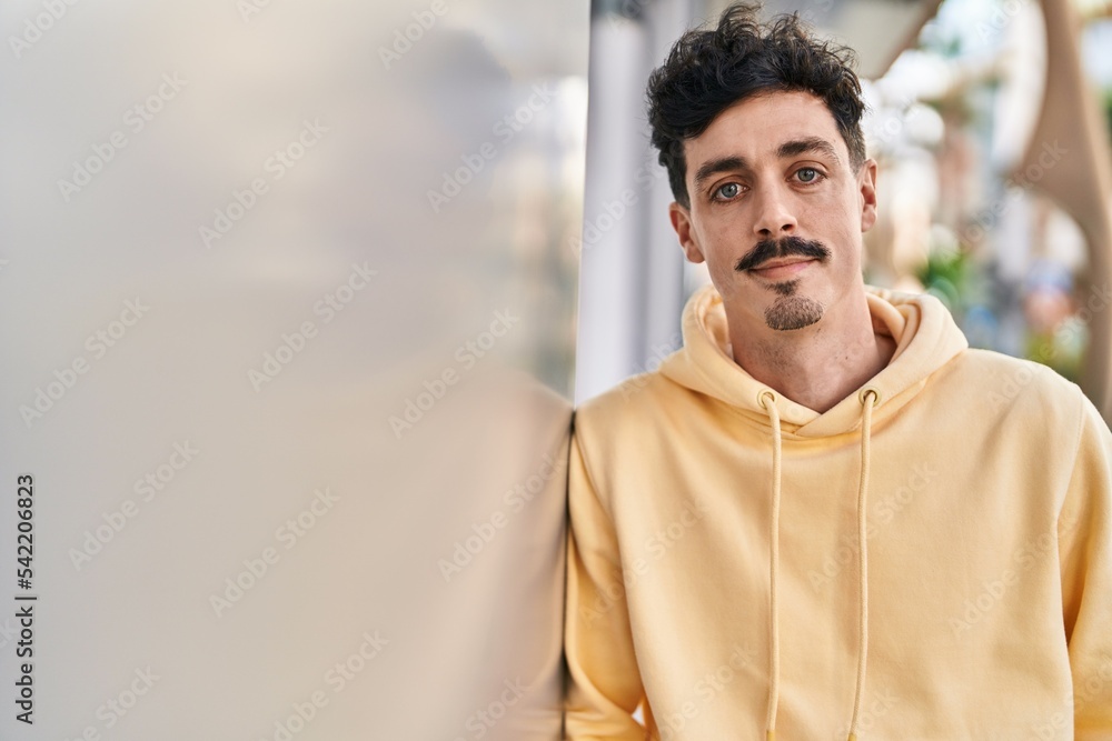 Young caucasian man standing with serious expression at street Young caucasian man standing with serious expression at street