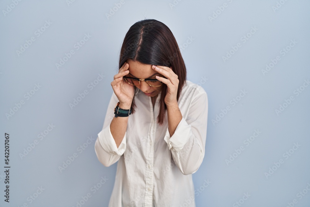 Young hispanic woman standing over white background with sad expression covering face with hands while crying. depression concept. Young hispanic woman standing over white background with sad expression covering face with hands while crying. depression concept.