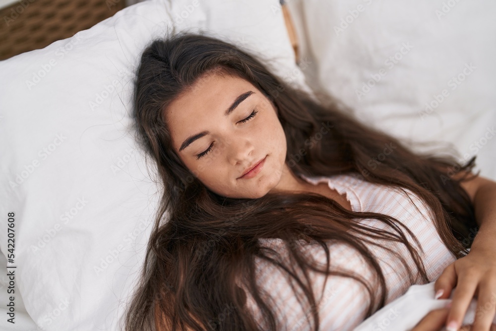 Young hispanic woman lying on bed sleeping at bedroom Young hispanic woman lying on bed sleeping at bedroom