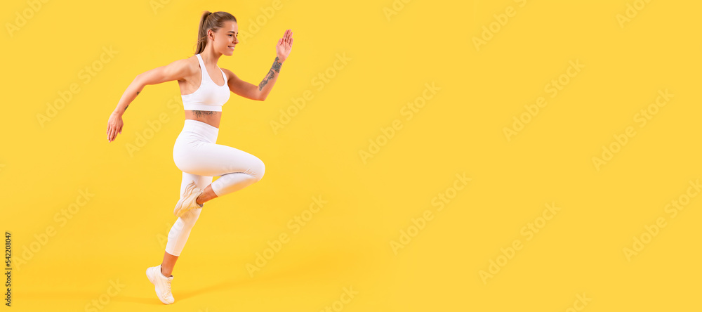fitness girl runner running on yellow background. Woman jumping running banner with mock up copyspace.