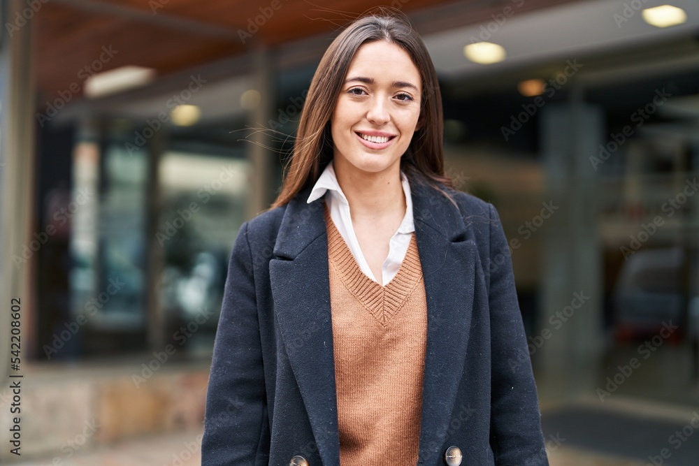 Fototapeta premium Young beautiful hispanic woman smiling confident standing at street