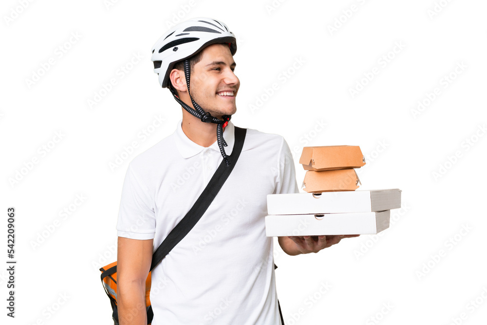 Young caucasian man with thermal backpack over isolated background looking side Young caucasian man with thermal backpack over isolated background looking side