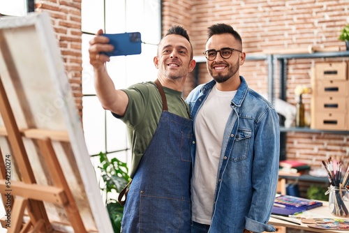 Two men artists smiling confident make selfie by smartphone at art studio