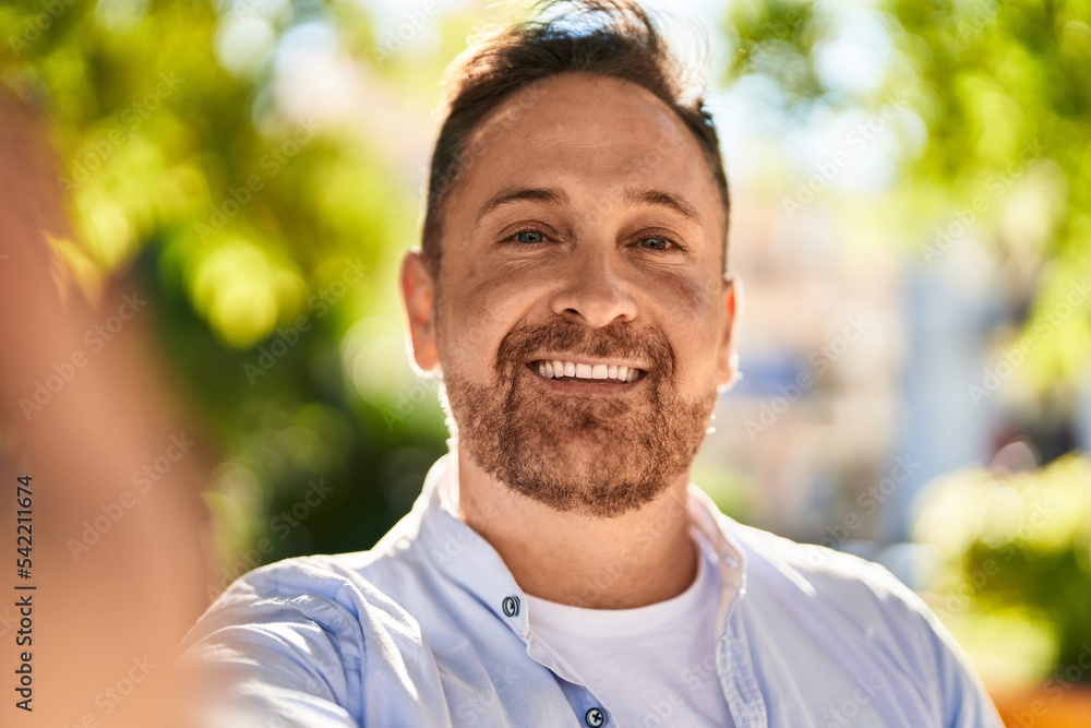 Young caucasian man smiling confident making selfie by camera at park