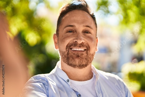 Young caucasian man smiling confident making selfie by camera at park