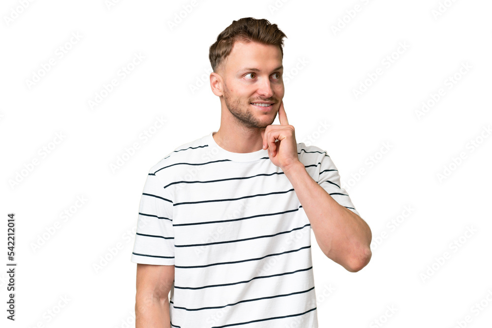 Young blonde caucasian man over isolated background thinking an idea while looking up Young blonde caucasian man over isolated background thinking an idea while looking up