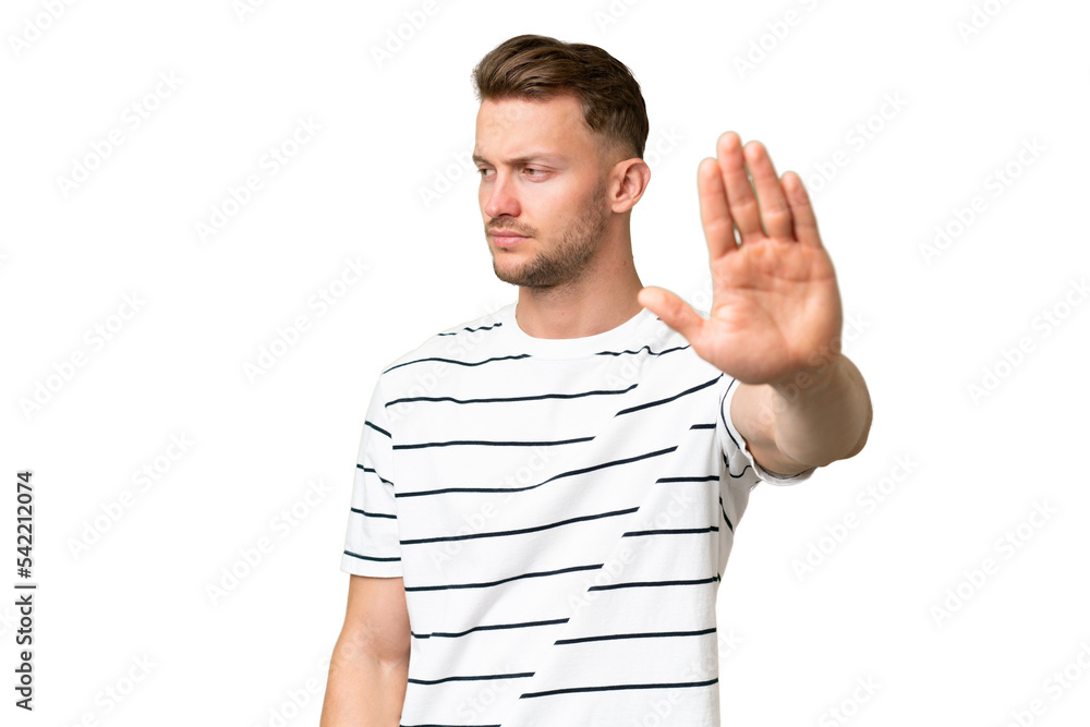 Young blonde caucasian man over isolated background making stop gesture and disappointed Young blonde caucasian man over isolated background making stop gesture and disappointed