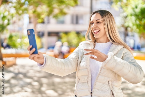 Young woman smiling confident having video call at park