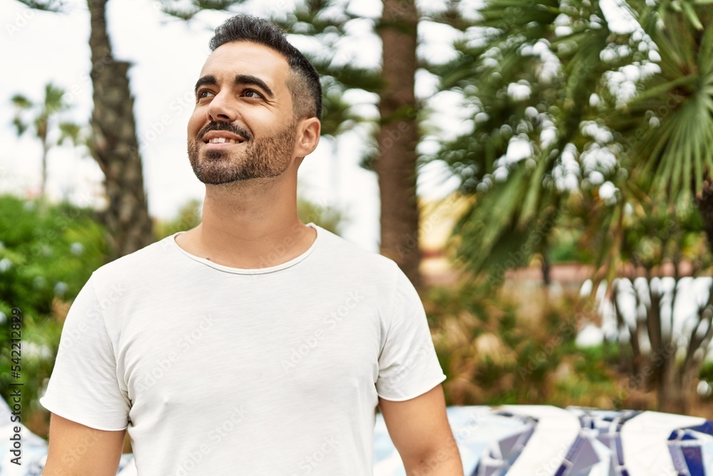 Young hispanic man smiling confident walking at park
