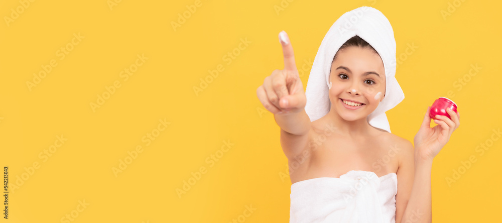 happy teen girl in shower towel apply facial cream. selective focus. Cosmetics and skin care for teenager child, poster design. Beauty kid girl banner with copy space. happy teen girl in shower towel apply facial cream. selective focus. Cosmetics and skin care for teenager child, poster design. Beauty kid girl banner with copy space.