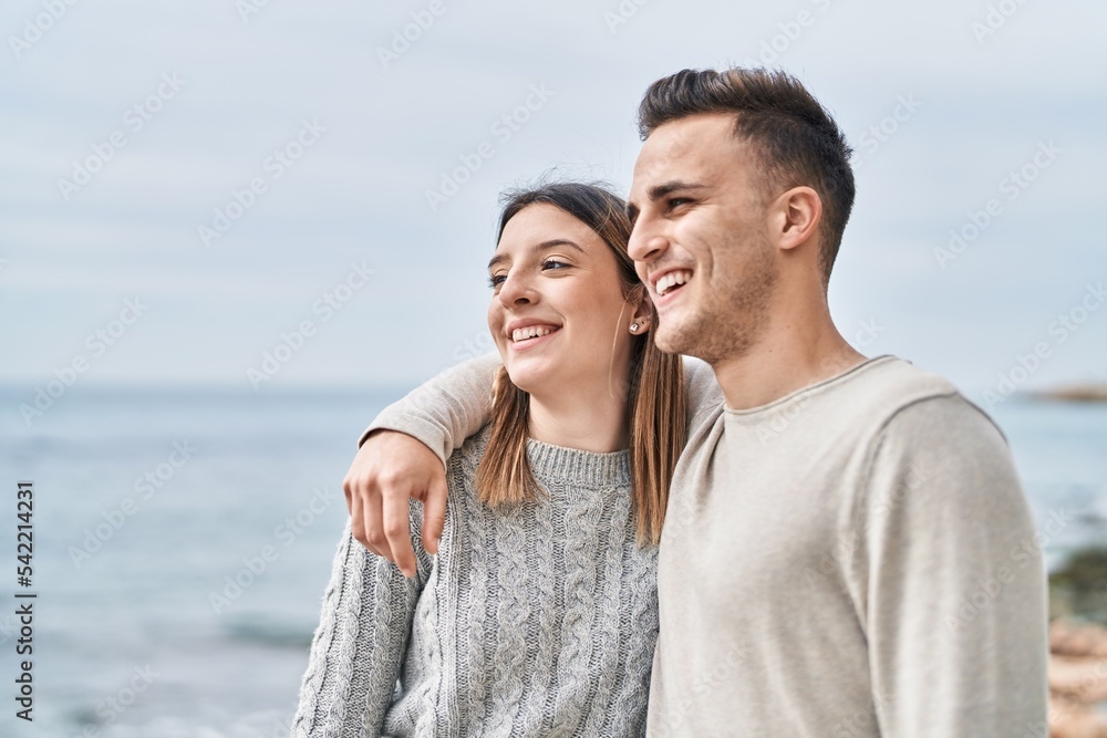 Man and woman couple smiling confident hugging each other at seaside Man and woman couple smiling confident hugging each other at seaside
