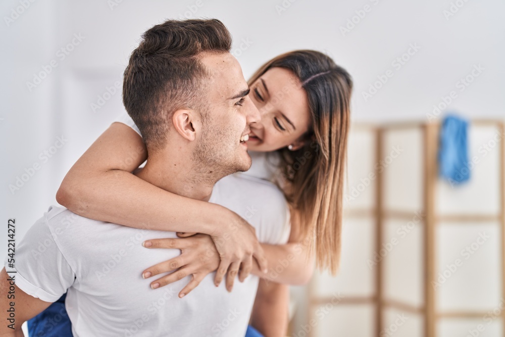 Man and woman couple holding on back standing at bedroom Man and woman couple holding on back standing at bedroom