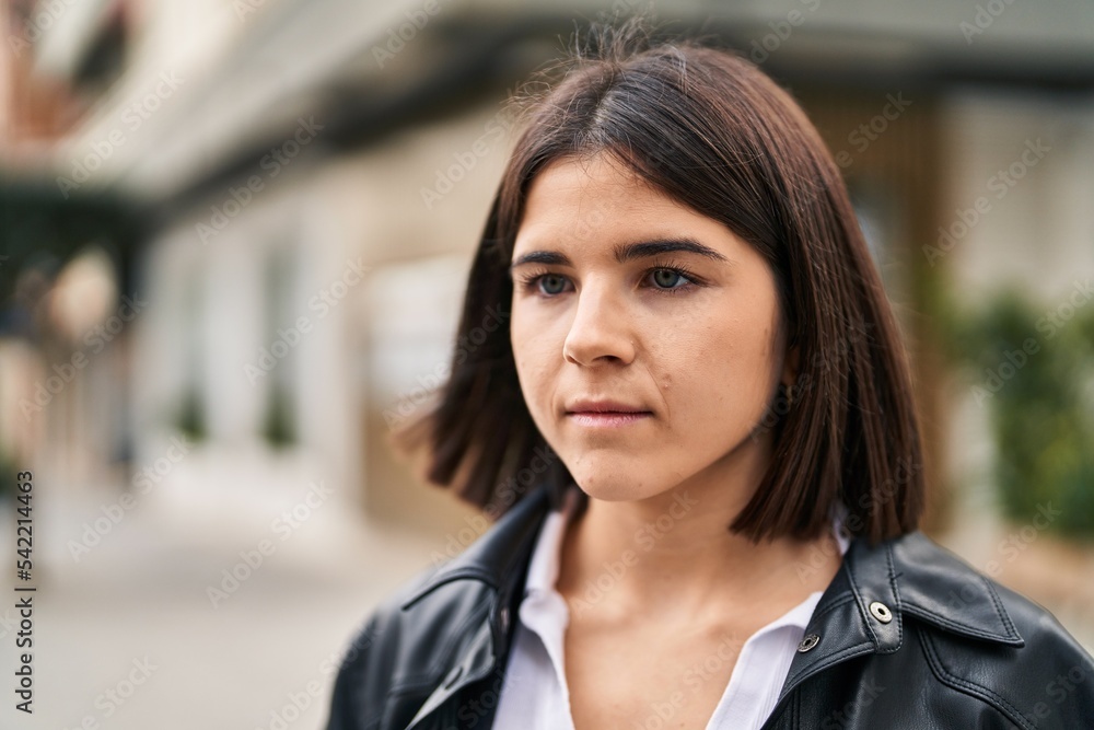 Young beautiful hispanic woman looking to the side with serious expression at street Young beautiful hispanic woman looking to the side with serious expression at street