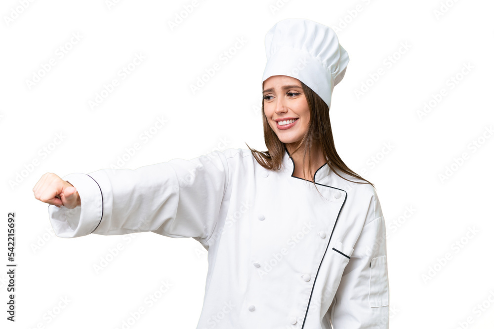 Young chef caucasian woman over isolated background giving a thumbs up gesture