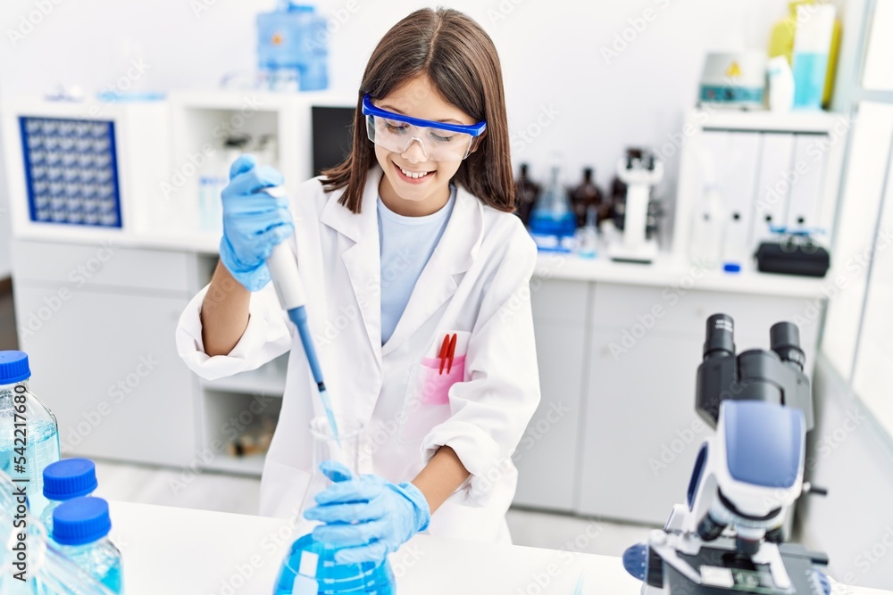 Young hispanic girl working using pipette at laboratory Young hispanic girl working using pipette at laboratory