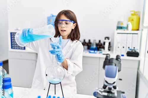 Young hispanic girl working at laboratory