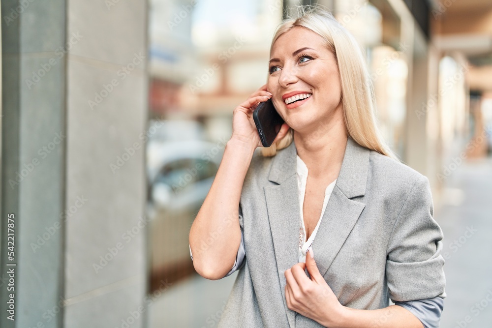 Young blonde woman smiling confident using smartphone at street Young blonde woman smiling confident using smartphone at street