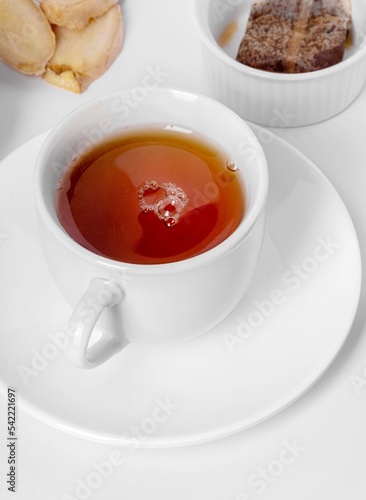A cup of fresh tea with lemon and ginger. White background, isolated white. Close up.