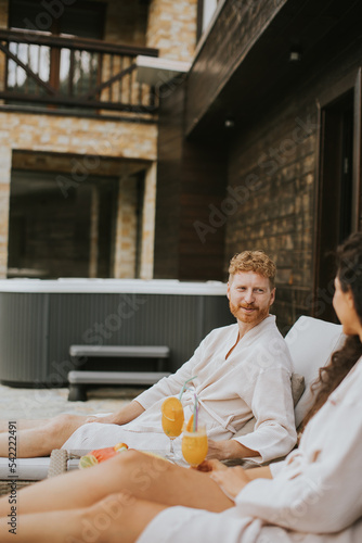 Young couple relaxing on be...