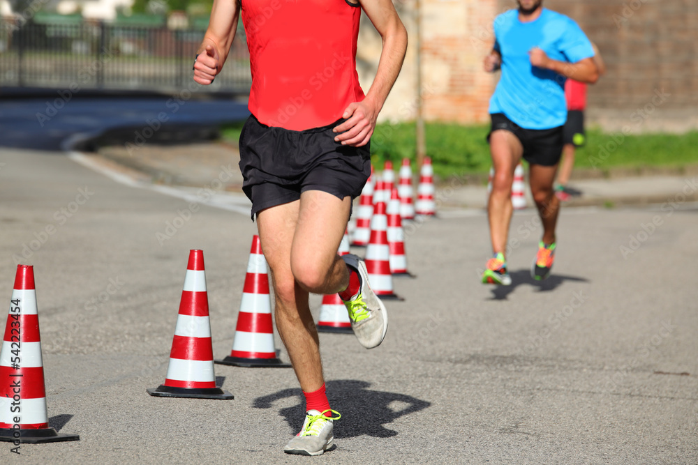 athletic runner with long muscular legs during the foot race athletic runner with long muscular legs during the foot race