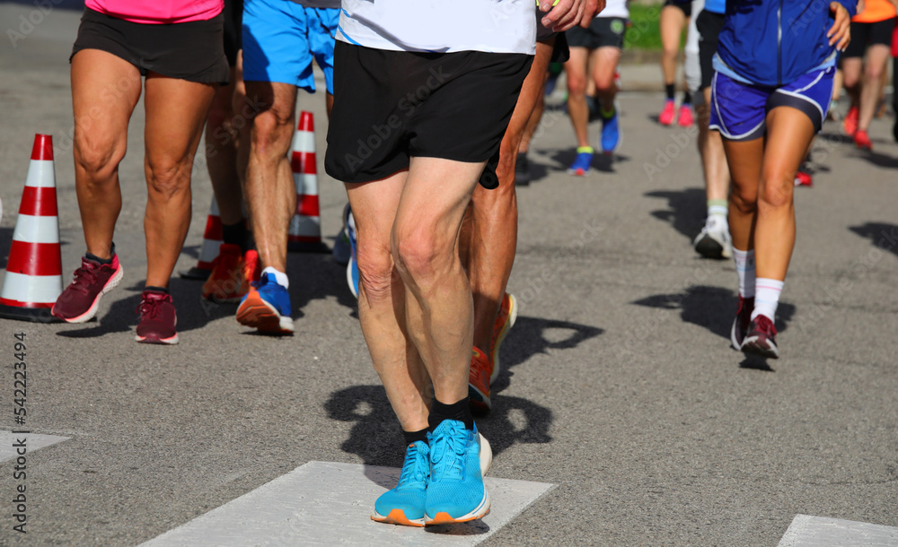 Athletic runners with muscular legs during the competitive run