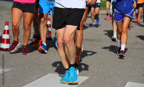 Athletic runners with muscular legs during the competitive run