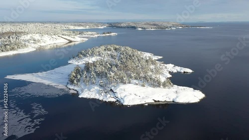 National Park Ladoga Skerries, in winter in Karelia Russia Small stone islands in the snow on Lake Ladoga on a sunny day