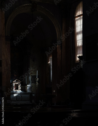 dark interior of a gothic baroque church in Venice, Italy