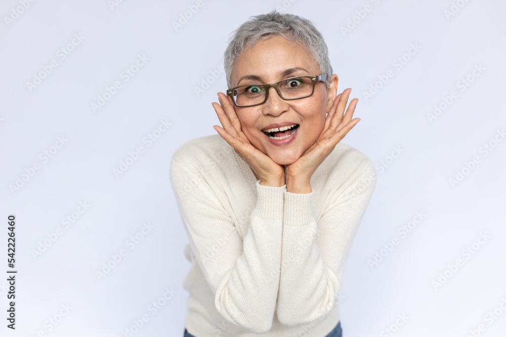 Portrait of excited senior woman looking at camera in admiration. Mature Caucasian woman wearing eyeglasses and white jumper expressing love and affection. Admiration concept Portrait of excited senior woman looking at camera in admiration. Mature Caucasian woman wearing eyeglasses and white jumper expressing love and affection. Admiration concept