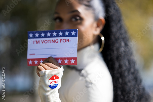 South Indian Woman Holding Voting Materials (Signs and Stickers)