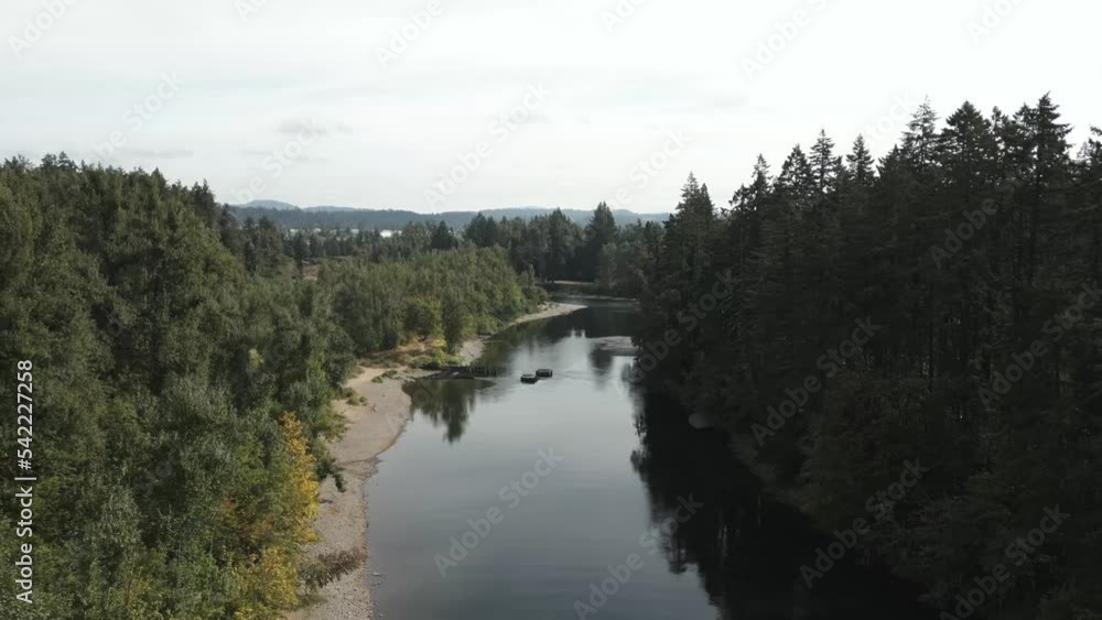 Aerial above Clackamus River in Portland Oregon lined with pine trees Aerial above Clackamus River in Portland Oregon lined with pine trees