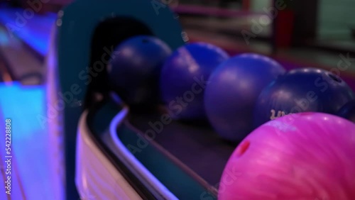 Close-up of hand takes the bowling ball, fingers get into holes