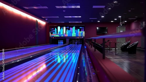 One man throwing a bowling ball and knocks out all the pins, make a strike hit in the pocket