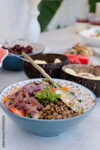 A refreshing salad bowl with green lentils and purple mixed on the food serving table. A lentil salad that looks amazing.