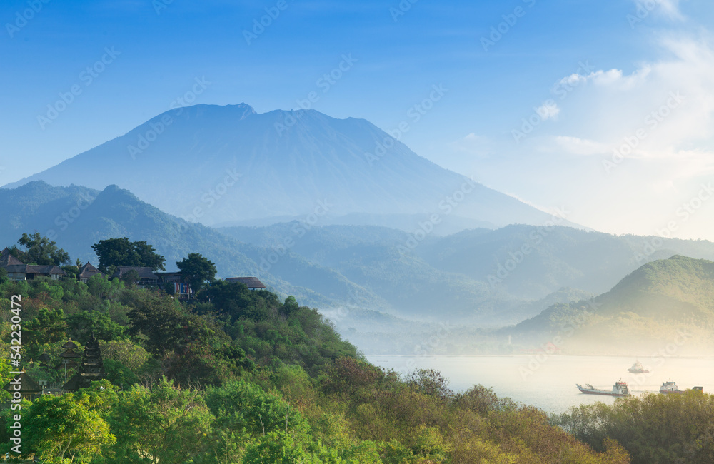 Aerial Of Amazing Agung Volcano Over Lush Green Tropical Forest With Ships And Ocean, Bali, Indonesia