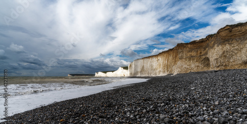 rocky beach at Birling Gap with the cliffs of the Seven Sisters in the background on the Jurassic Coast of East Sussex photo