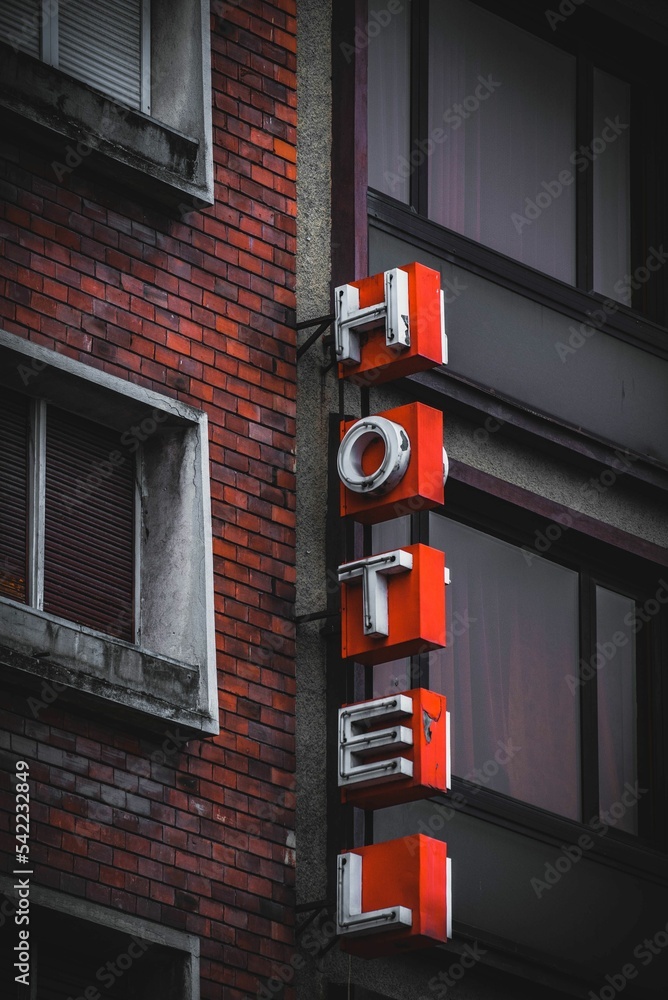 Vertical shot of an old hotel sign on a brick building Vertical shot of an old hotel sign on a brick building